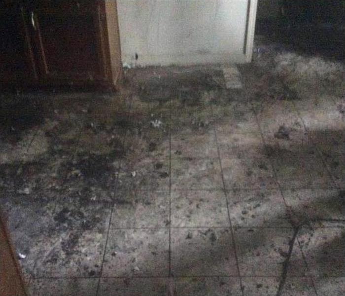 cleared floor, removed debris, still soot visible