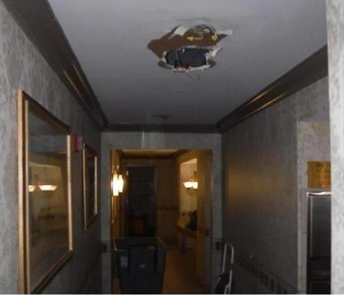 holes in ceiling of corridor from water leak