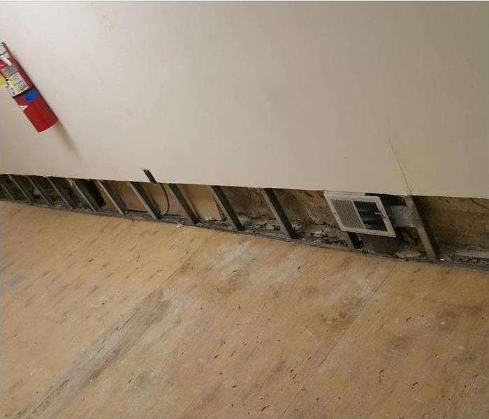 stripped flooring to plywood, two-foot wall cuts, fire extinguisher on the wall