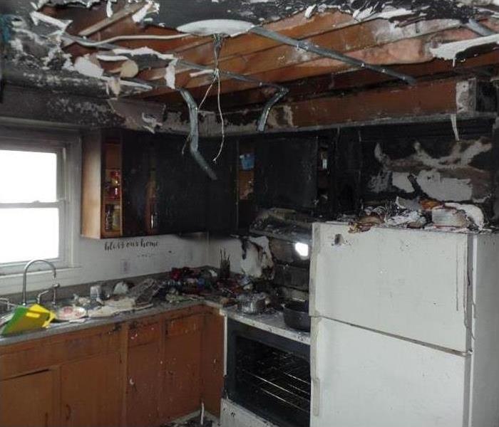 fire damaged ceiling and kitchen, range, sink