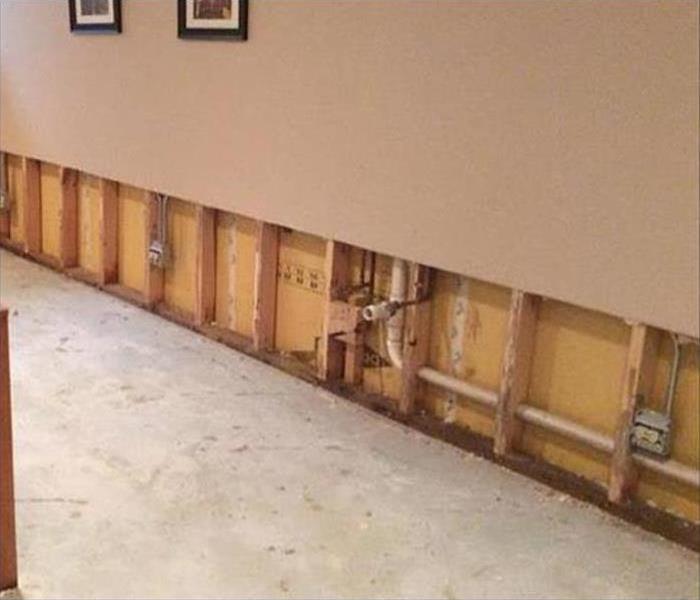 removed carpet, cut out drywall showing the plumbing