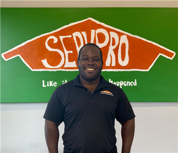 man in front of Servpro sign